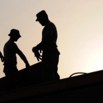 Sobras de hombres trabajando en construcción. foto tomada a contraluz.Inspección vigilancia control tercerización laboral